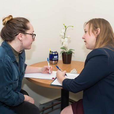 A student speaking with a staff member